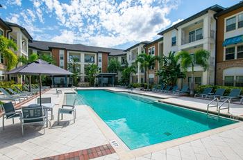 Relaxing pool with cabanas & hot tub